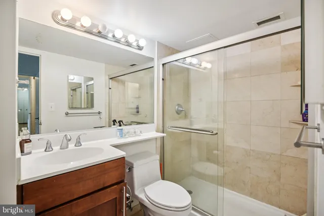 a bathroom with a sink toilet a mirror and shower