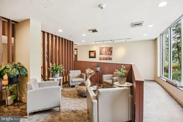 a living room with furniture and a large window