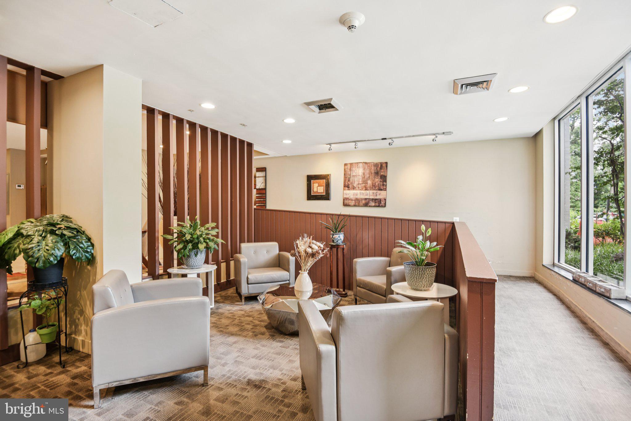 7333 New Hampshire Avenue, Unit 311S Takoma Park, MD 20912 - Photo 2 of 27 a living room with furniture and a large window