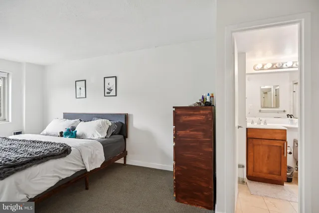 a bedroom with a bed and a dresser