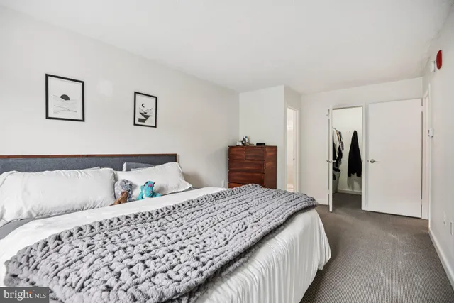 a bedroom with a large bed and dresser