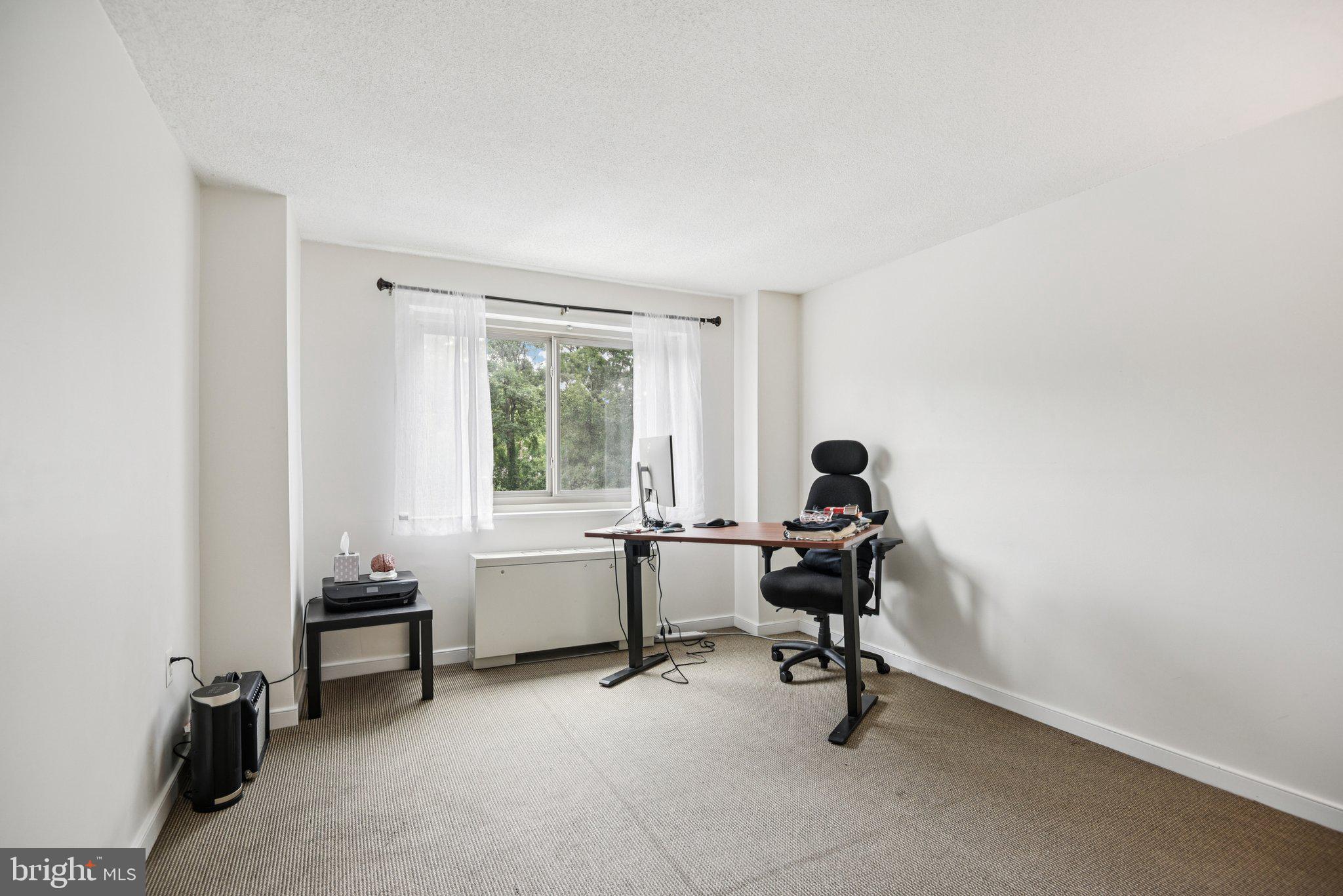 7333 New Hampshire Avenue, Unit 311S Takoma Park, MD 20912 - Photo 26 of 27 a view of a workspace with furniture and a window