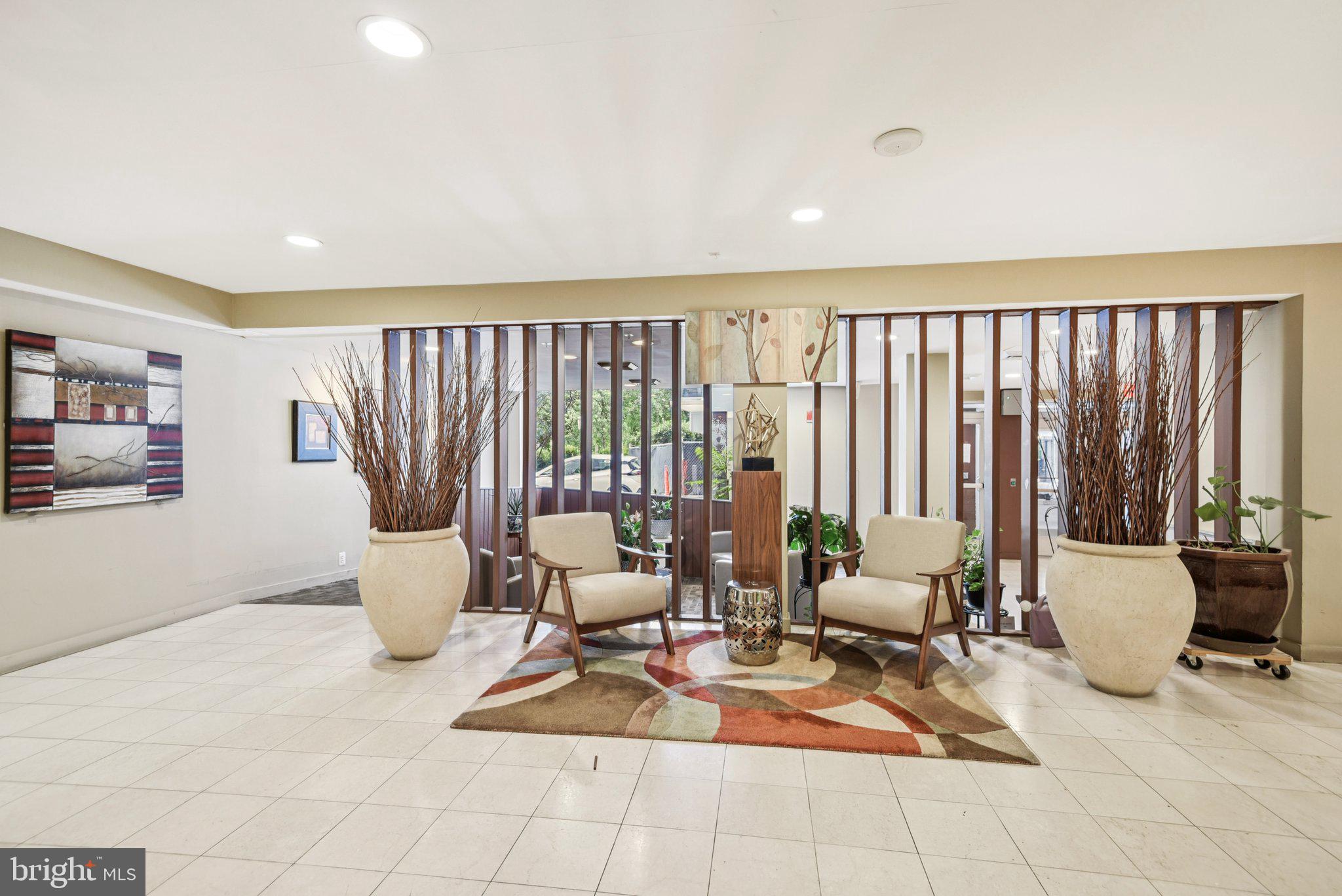 7333 New Hampshire Avenue, Unit 311S Takoma Park, MD 20912 - Photo 3 of 27 a living room with a large window and a table