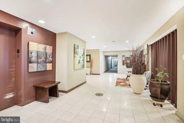 a living room with furniture a rug and white walls