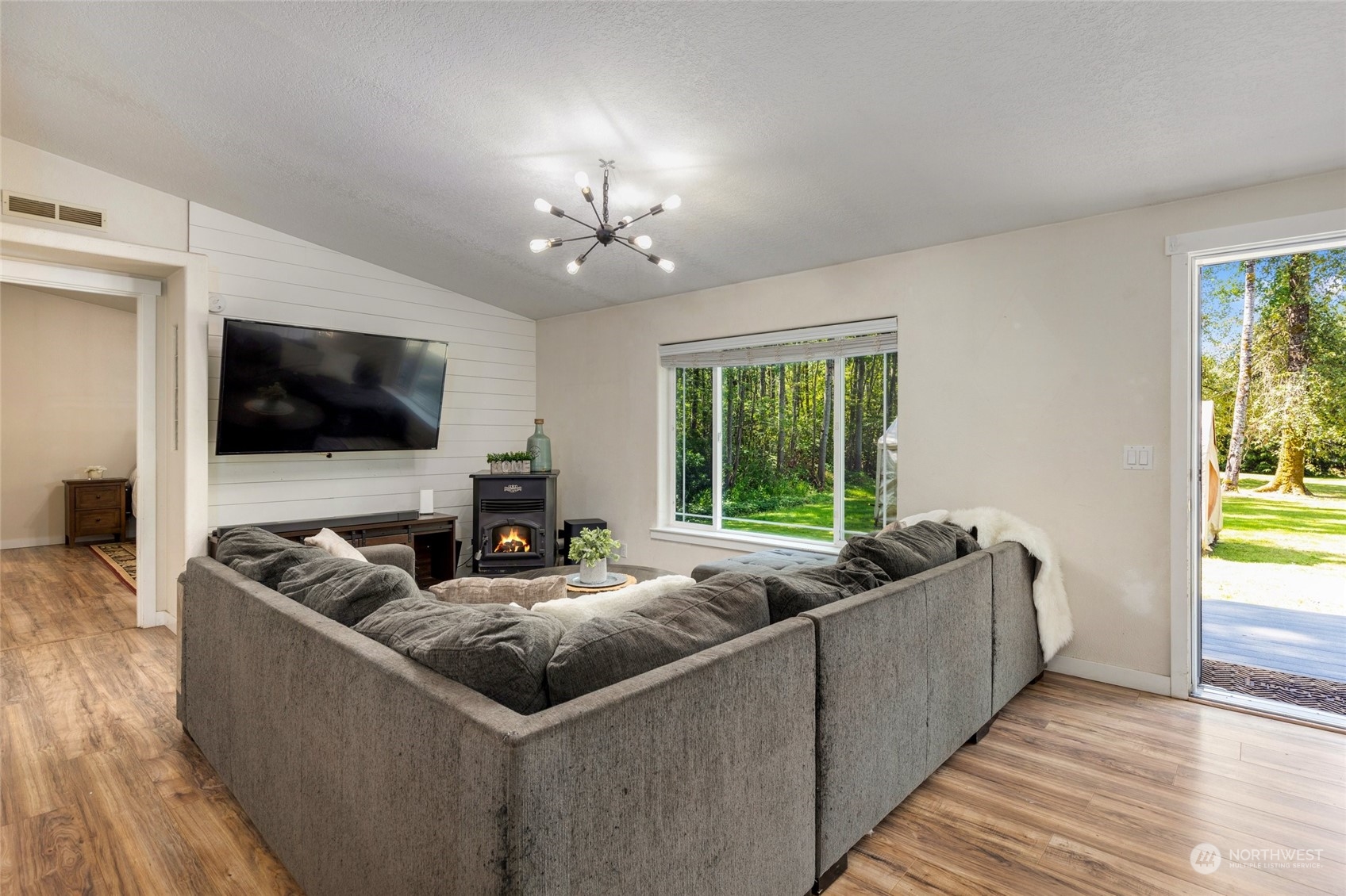 7942 Crockett Road Blaine, WA 98230 - Photo 12 of 33 a living room with furniture and a flat screen tv
