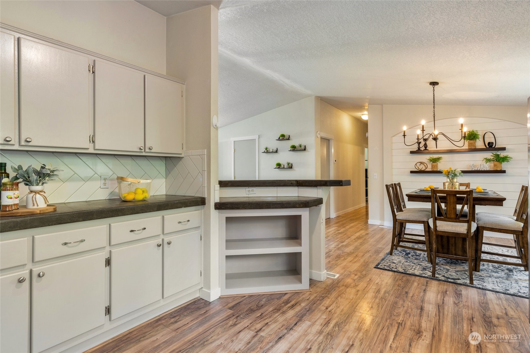 7942 Crockett Road Blaine, WA 98230 - Photo 17 of 33 a kitchen with granite countertop a white cabinets and chairs