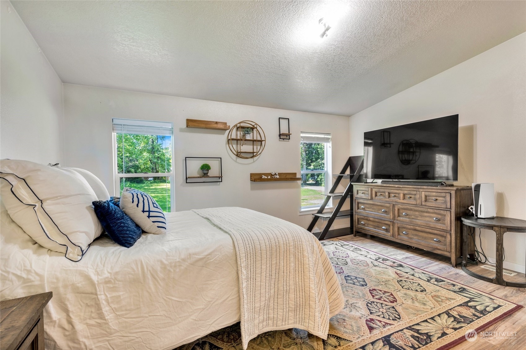 7942 Crockett Road Blaine, WA 98230 - Photo 22 of 33 a bedroom with a bed and a flat screen tv