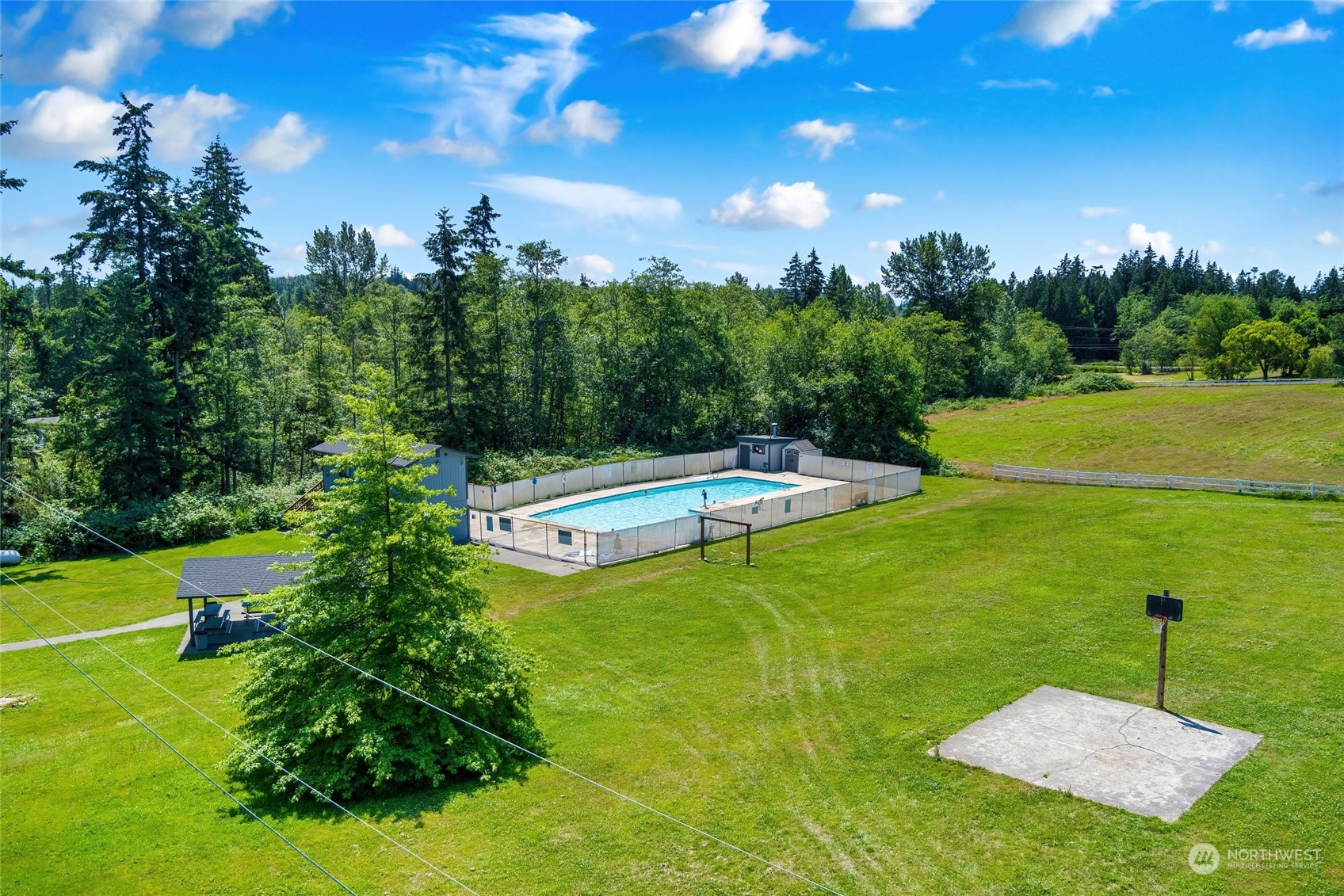 7942 Crockett Road Blaine, WA 98230 - Photo 7 of 33 a view of a swimming pool with a yard