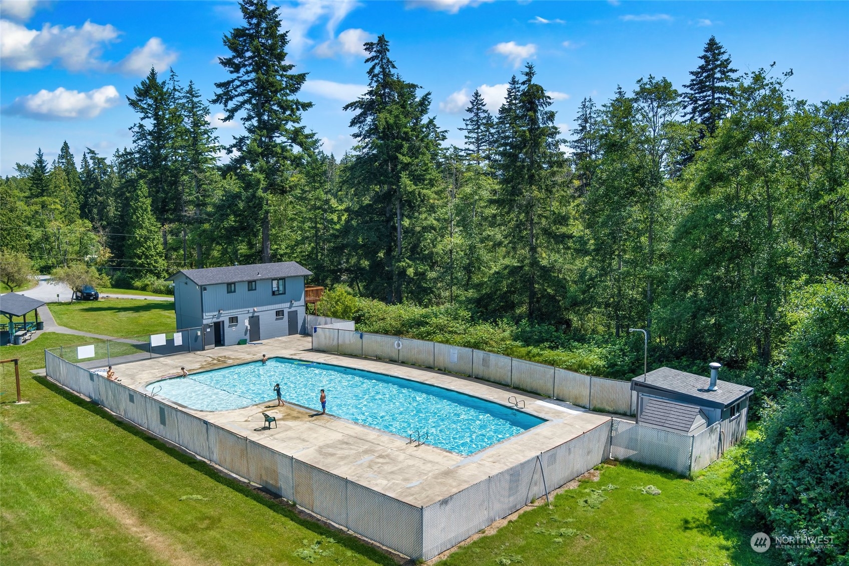 7942 Crockett Road Blaine, WA 98230 - Photo 8 of 33 swimming pool with outdoor seating and trees in the background
