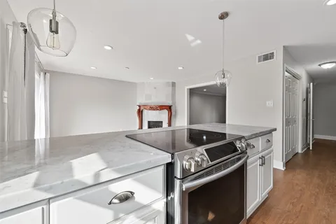 a kitchen with granite countertop a sink and cabinets