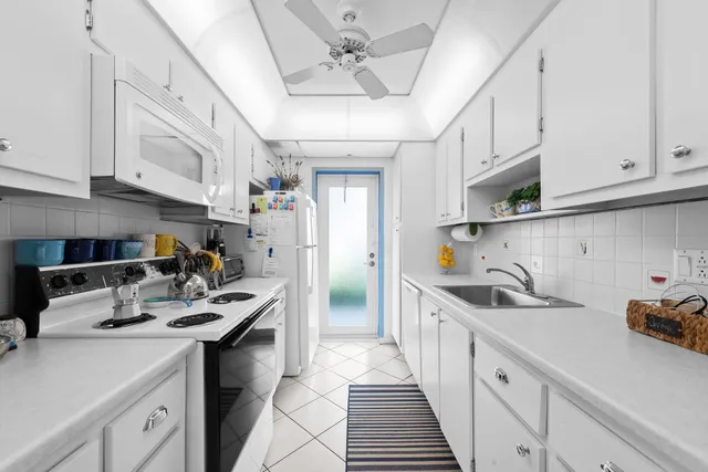 a kitchen with stainless steel appliances a sink dishwasher stove refrigerator and cabinets