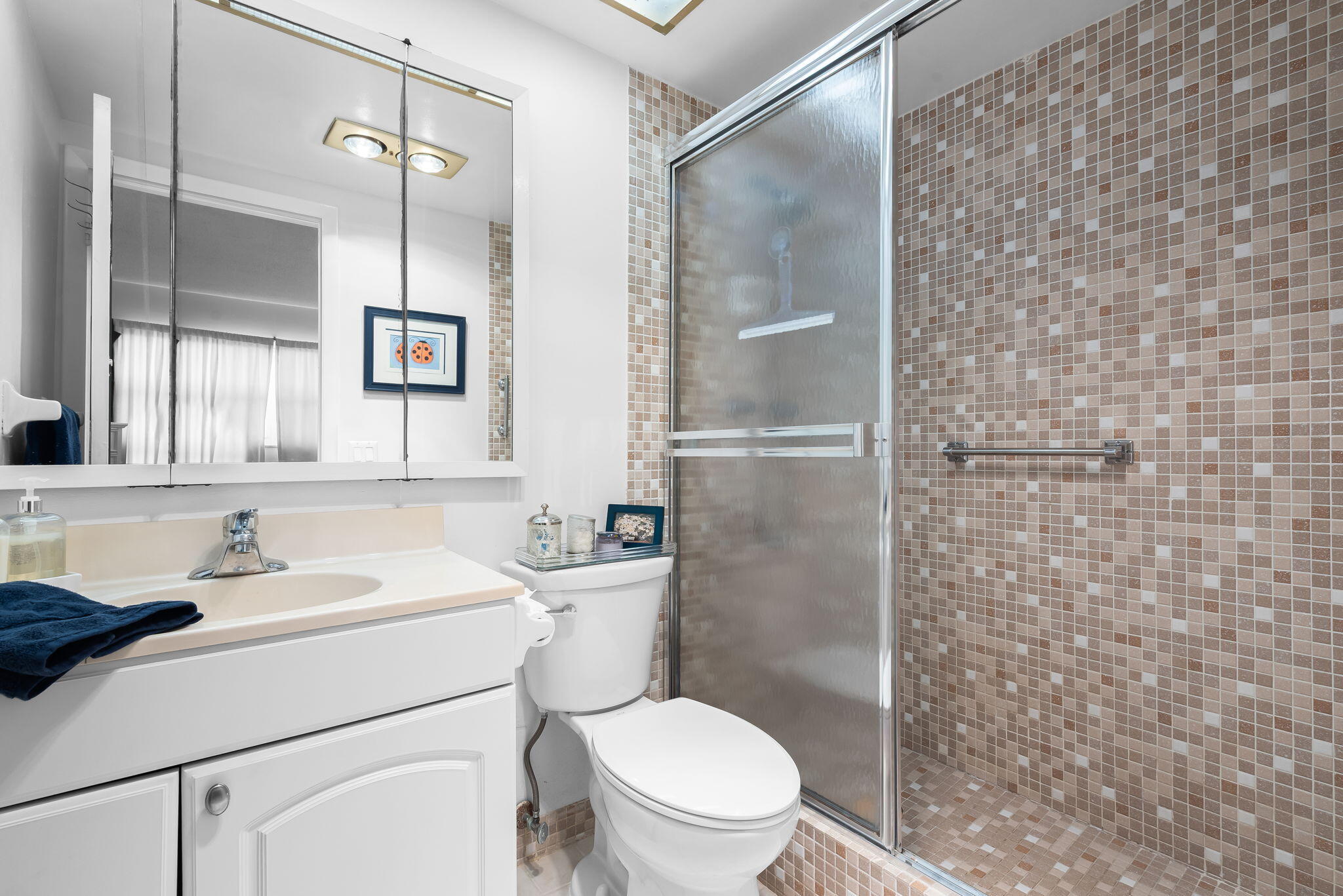 3101 South Ocean Boulevard, Unit 102 Highland Beach, FL 33487 - Photo 12 of 19 a bathroom with a sink a toilet and shower