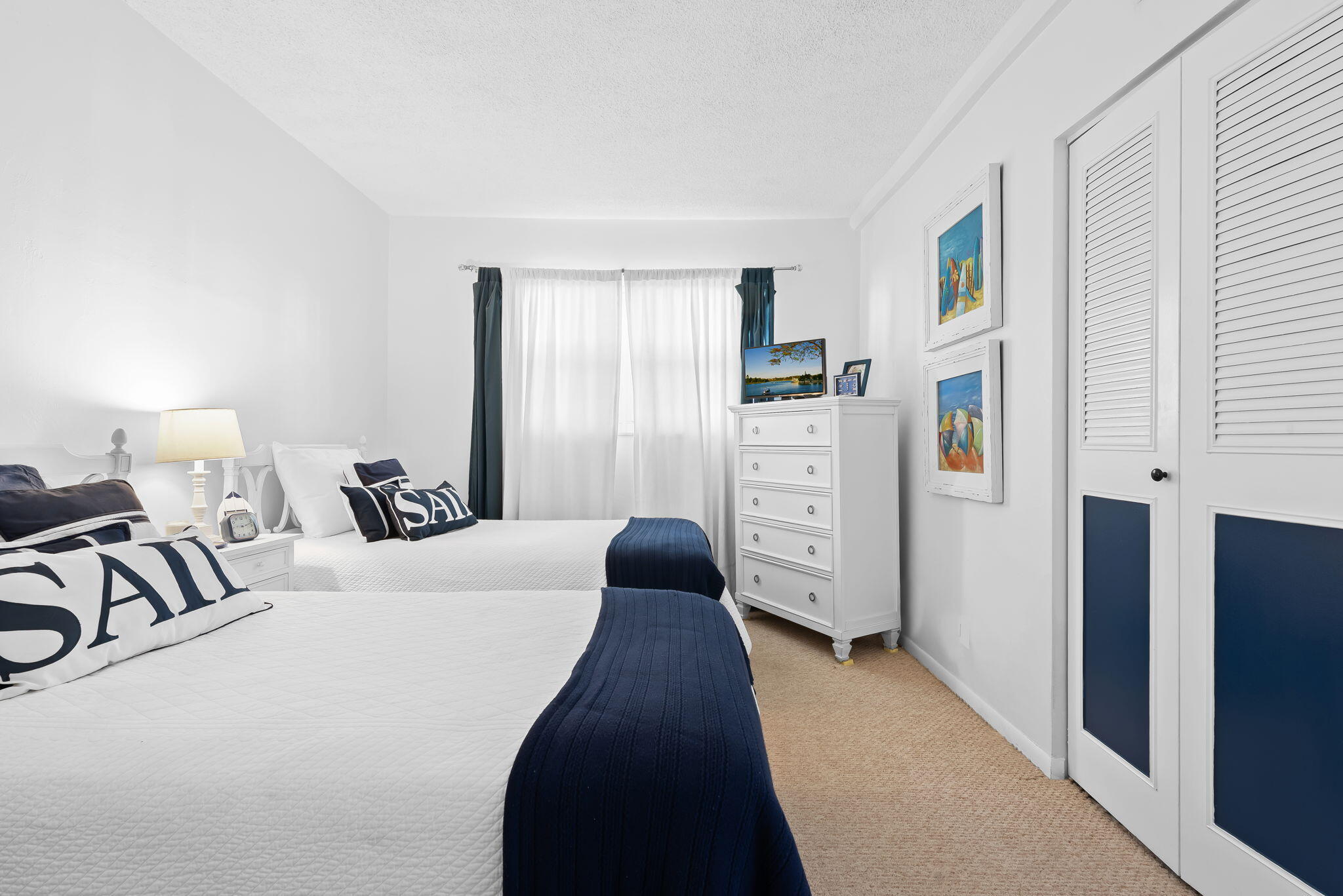 3101 South Ocean Boulevard, Unit 102 Highland Beach, FL 33487 - Photo 18 of 19 a bedroom with a bed and a walk in closet