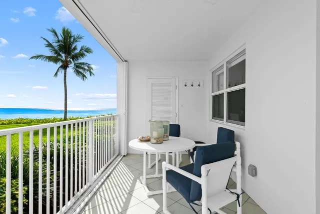a view of a balcony with furniture and a potted plants