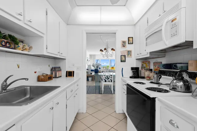a kitchen with a sink cabinets and appliances