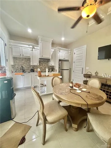 a kitchen with a table chairs stove and cabinets