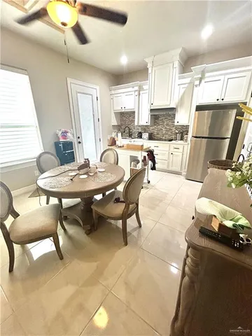 a living room with furniture a dining table and kitchen view