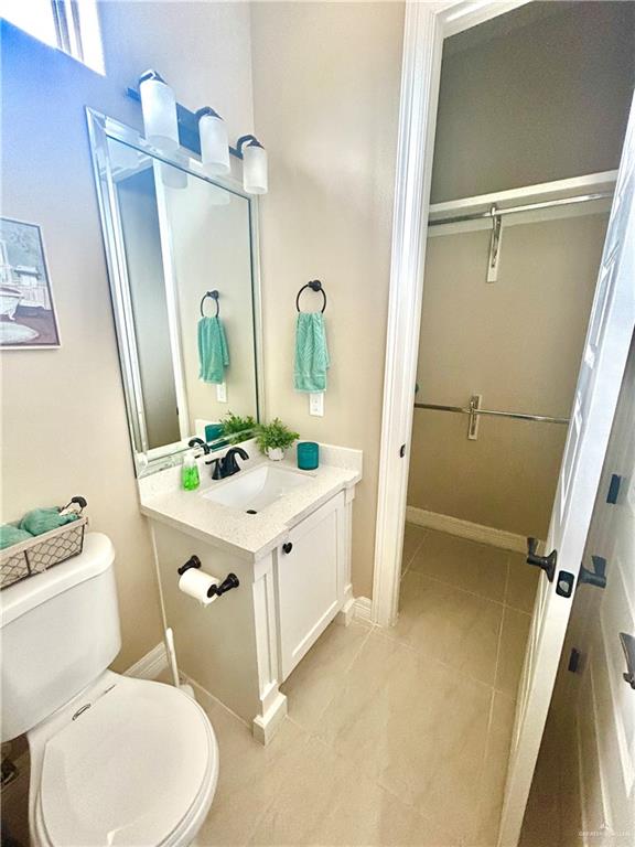 1329 North Cesar Chavez Road Edinburg, TX 78542 - Photo 5 of 10 a bathroom with a sink a toilet a mirror and shower