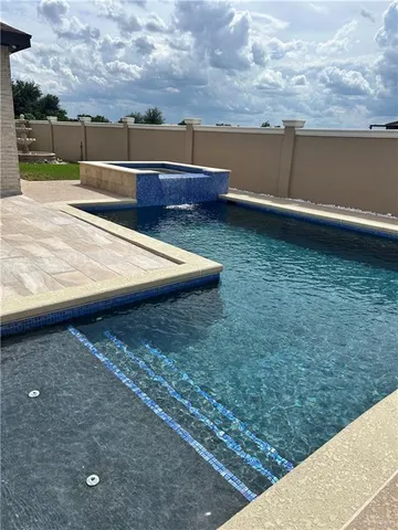 a view of a backyard with lawn chairs