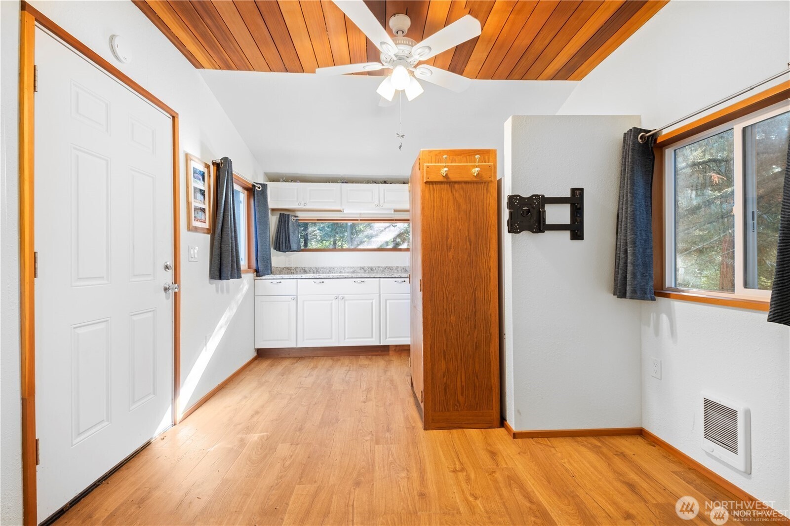 14310 200th Avenue Southeast Renton, WA 98058 - Photo 12 of 39 a view of a room with wooden floor and a refrigerator