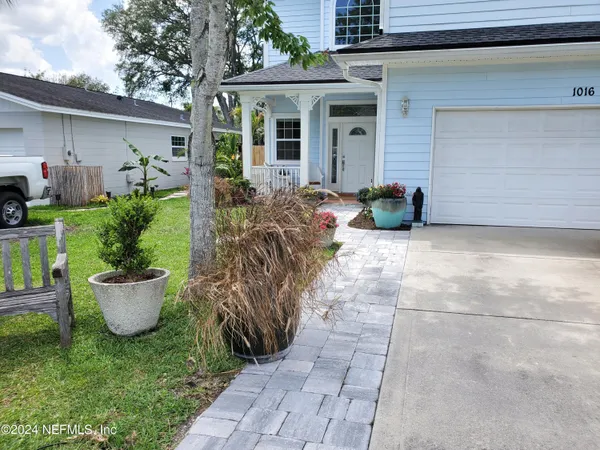 a front view of house with yard and green space