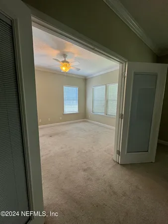 a view of a hallway with window and stairs
