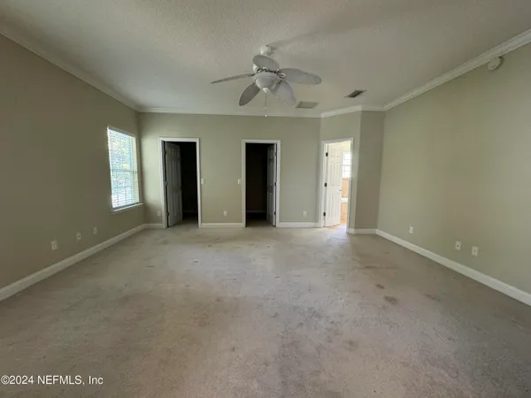 a view of a room with wooden floor and window