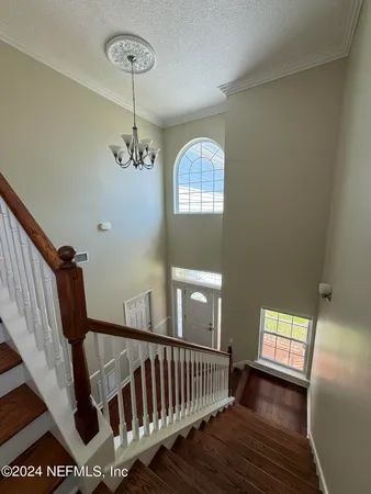 a kitchen with stainless steel appliances granite countertop a stove a sink and white cabinets