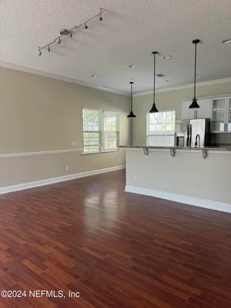 a view of a kitchen with wooden floor and a ceiling fan