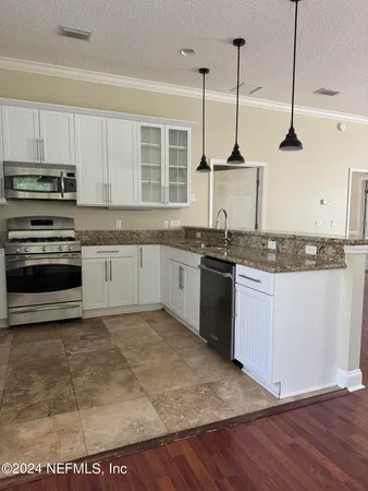 a view of a yard with wooden fence