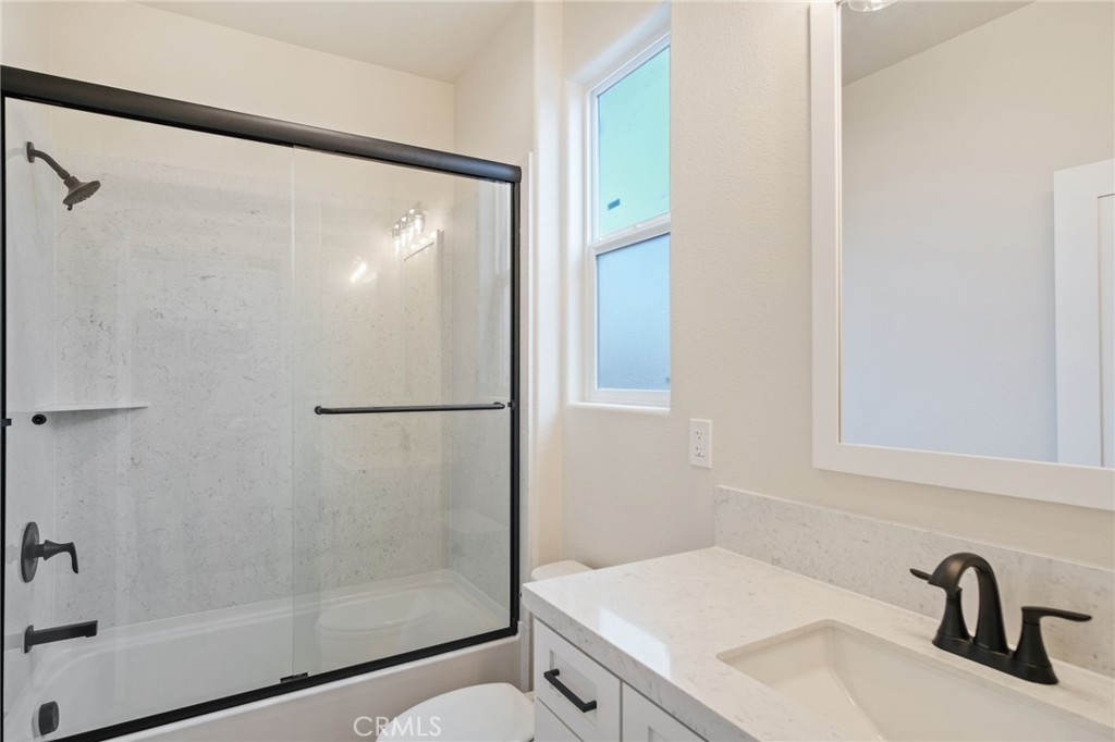 243 East 3rd Street Tracy, CA 95376 - Photo 12 of 29 a bathroom with a shower and a sink