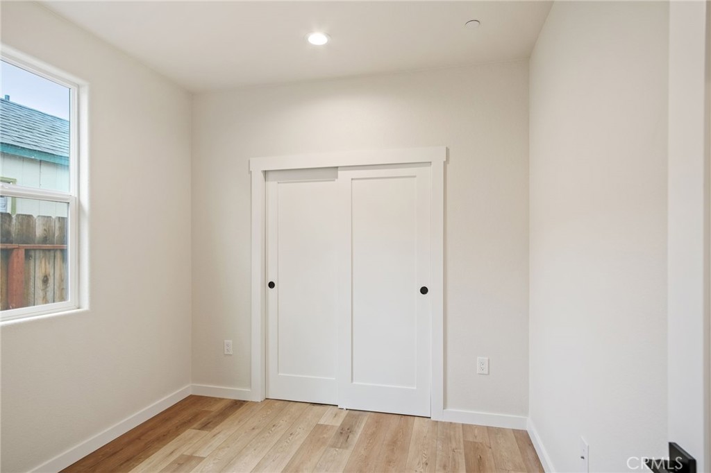 243 East 3rd Street Tracy, CA 95376 - Photo 22 of 29 an empty room with wooden floor and windows
