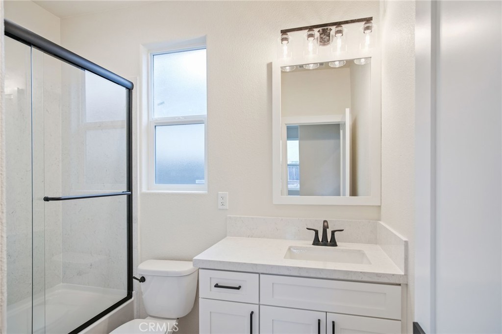 243 East 3rd Street Tracy, CA 95376 - Photo 23 of 29 a bathroom with a sink toilet and shower