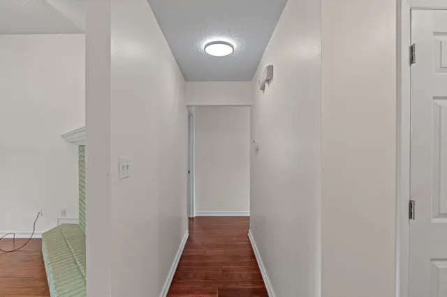 a view of hallway with wooden floor