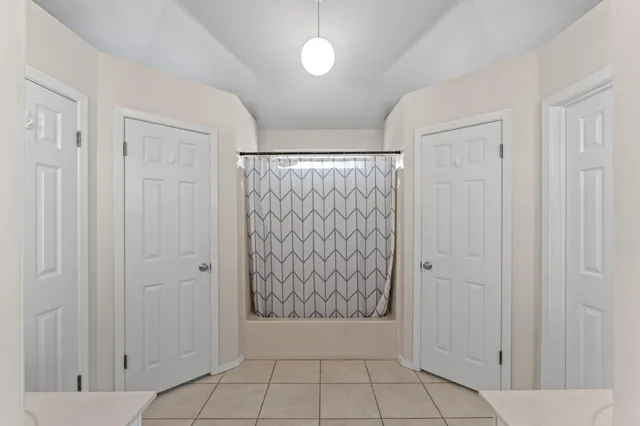 a bathroom with double vanity sinks and a mirror