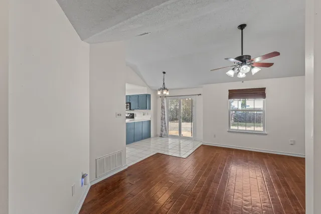 a view of a room with window and wooden floor