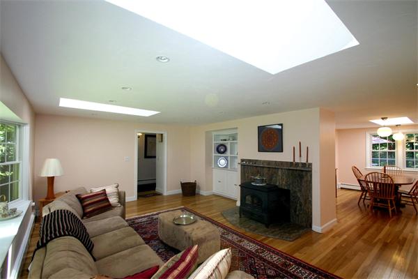 8 Longfellow Road Wayland, MA 01778 - Photo 5 of 24 a living room with furniture and a fireplace