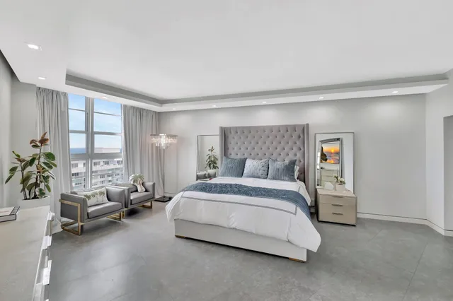 a spacious bedroom with a bed and a couch