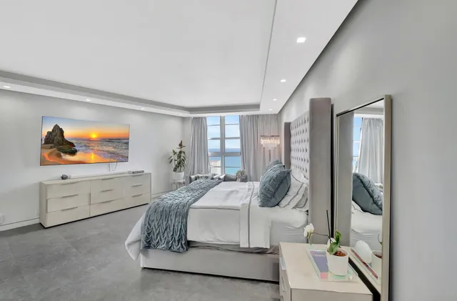 a spacious bedroom with a large bed and a window