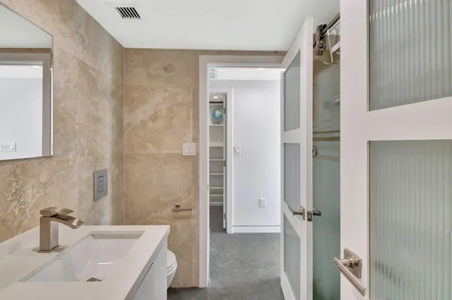a bathroom with a sink a shower and a mirror