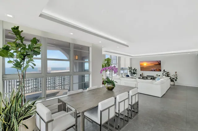 a living room with furniture and a potted plant