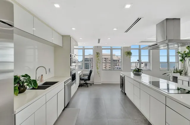 a large white kitchen with lots of counter space