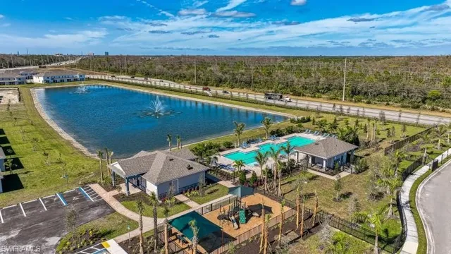 an aerial view of a house with a lake