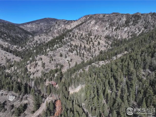 a view of a large mountain with mountains in the background
