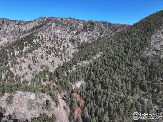 a view of a large mountain with mountains in the background
