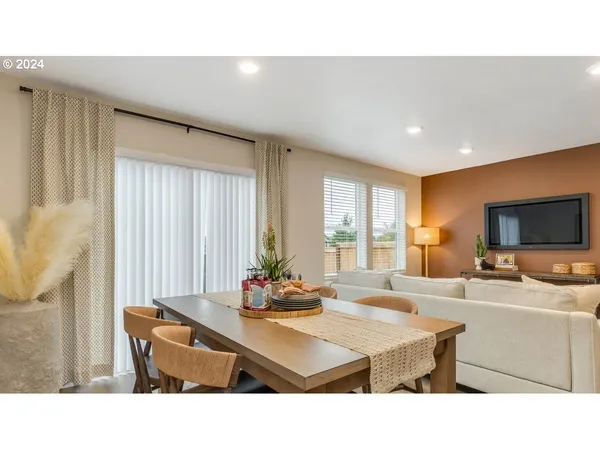 a living room with stainless steel appliances kitchen island granite countertop furniture and a large window