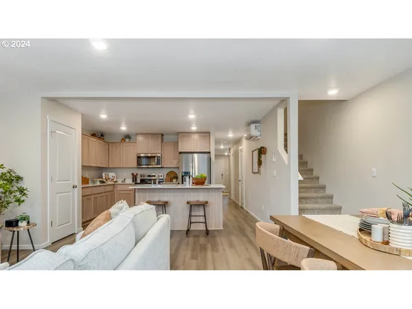 a living room with stainless steel appliances kitchen island granite countertop furniture and a kitchen view