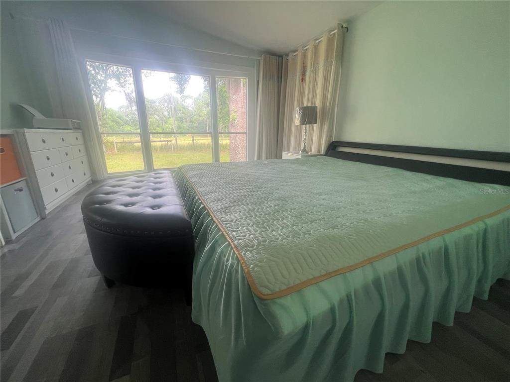 5855 Jack Brack Road St. Cloud, FL 34771 - Photo 19 of 86 a bedroom with a bed and a window