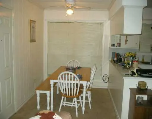a view of a dining room with furniture and a chandelier