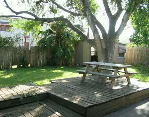 a view of a backyard with a garden and sitting area